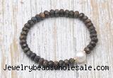 CFB754 faceted rondelle bronzite & potato white freshwater pearl stretchy bracelet